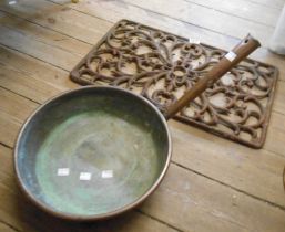 A copper pan and a decorative cast iron grill