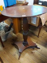 A 63.5cm antique mahogany oval topped pedestal table, set on turned and reeded pillar with