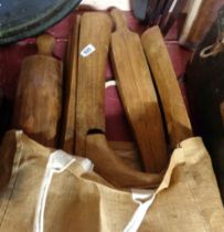 A bag containing two antique wooden boot trees