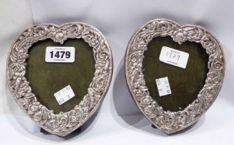 A pair of 15cm high marked 'sterling'/GL 915 heart shaped photograph frames with embossed floral and