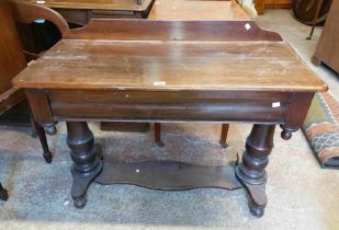 A 1.04m Victorian style stained pine side table with low raised back and blind frieze drawer, set on