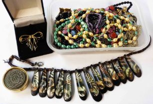 A tub containing vintage costume jewellery necklaces and other costume jewellery