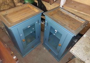 A pair of 56cm blue painted pine wall hanging cupboards, both with shelves enclosed by a single