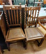 A pair of oak framed high lathe back dining chairs with flanking barley twist supports and drop-in