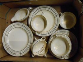 A crate containing a quantity of Clarice Cliff tableware including soup bowls, plates, etc.