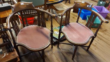 A pair of Edwardian inlaid mahogany framed corner elbow chairs with shell motifs to top rails and