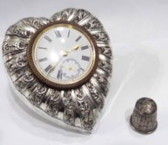 A silver mounted heart shaped bedside timepiece with embossed decoration, lever watch movement and