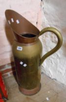 A large copper and brass jug