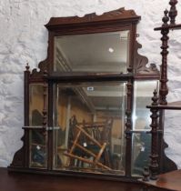 An Edwardian walnut overmantel mirror with multiple bevelled plates and flanking display shelves -