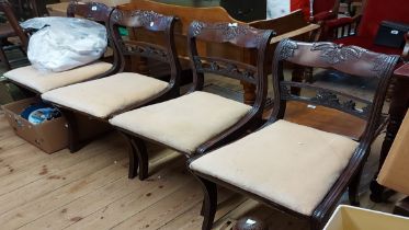 Five matching 19th Century mahogany framed sabre leg dining chairs with decorative top rails and
