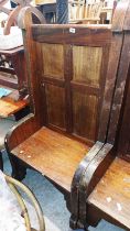 A 74cm vintage French clergy pew with panelled back, raised side rails and solid seat, set on shaped