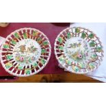 A pair of Lille French faience plates with pierced rims and central hand painted panels, depicting