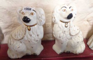 A pair of 20th Century Staffordshire comforter spaniels