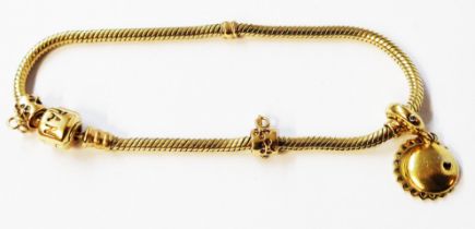 A genuine Pandora 585 (14ct.) gold snake-link bracelet with one charm and two charm suspenders -