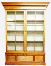 A 1.66m stripped pine ex-museum book cabinet with moulded cornice and painted adjustable shelves