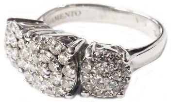 A Chimento import marked 750 (18ct.) white gold ring, with three diamond cluster settings - size L