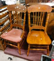 A set of four American style stained oak framed spindle back dining chairs with 'gingerbread' top
