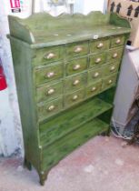 A 95cm green painted wood waterfall bookcase with sixteen added small file drawers and two open