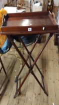 A 69cm vintage mahogany butler's tray top table, set on a folding X-frame base