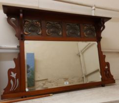 A 1.1m Art Nouveau walnut overmantel mirror with embossed copper panelled frieze and bevelled oblong