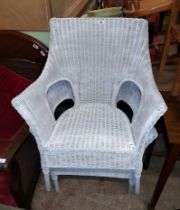 A pair of white painted wicker elbow chairs