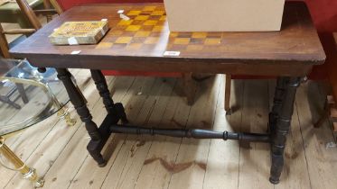 An 83cm Victorian mahogany games table with inlaid chess board top, set on turned standard ends -