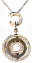 An import marked 750/18k pink gold Y&M designer pendant necklace with pierced concentric swivel disc