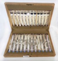 An oak canteen containing twelve each silver plated fish knives and forks