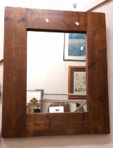 A modern rustic stained wood plank framed oblong wall mirror