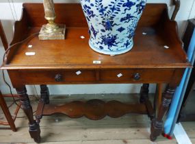 A 96cm late Victorian mahogany washstand with shaped splashback and two frieze drawers, set on