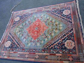 A French machine made middle eastern 'Senneh' rug with large central motif and corner bosses