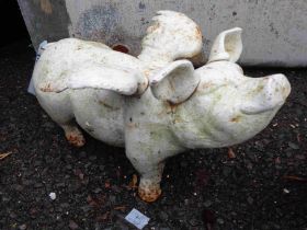 An old white painted cast iron ornament in the form of a winged pig