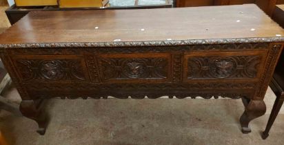 A 1.83m Victorian carved oak dresser base with lion mask handles to the three deep drawers, set on
