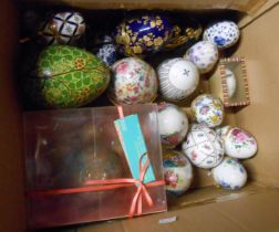 A box containing a quantity of decorative eggs including porcelain, lacquered, etc.