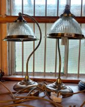 A pair of modern brass desk lamps with Holophane style shades