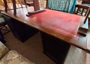 A 1.82m Edwardian oak twin pedestal partner's desk with red leather inset top, four pedestal drawers