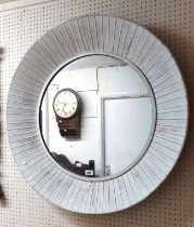An 82cm diameter modern painted pressed metal framed wall mirror with ribbed border