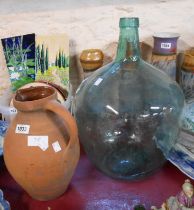 A large green glass carboy - sold with a terracotta milk jug