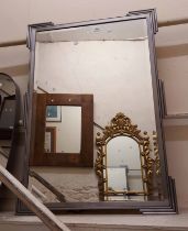 A modern metal framed bevelled oblong wall mirror with Art Deco style corners and sides