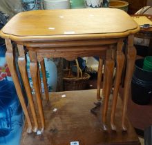 A reproduction walnut nest of three tea tables, set on cabriole legs with pad feet