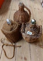 Three old wicker covered flagons and bottles