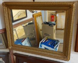 An ornate gilt gesso framed oblong wall mirror