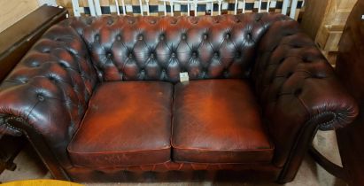 A 1.6m modern Chesterfield two seater settee with button back oxblood leather upholstery
