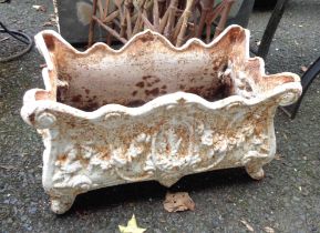 A 45cm antique French cast iron planter with ornate foliate scroll decoration