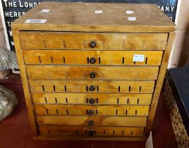 A small eight drawer chest containing a large quantity of bronze printing letters