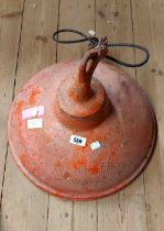 An old metal industrial style lampshade with red painted finish