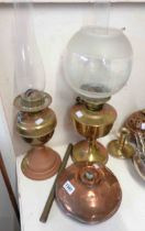 Two brass oil lamps both with chimneys, one with etched glass shade - sold with an old copper hot