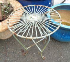 A small green painted wirework stool in the antique style