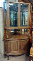 A 1.2m vintage oak freestanding corner display cabinet with mirrored interior and glass shelves