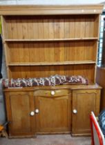 A 1.55m old pine two part dresser with moulded cornice and two shelf open plate rack with cup hooks,